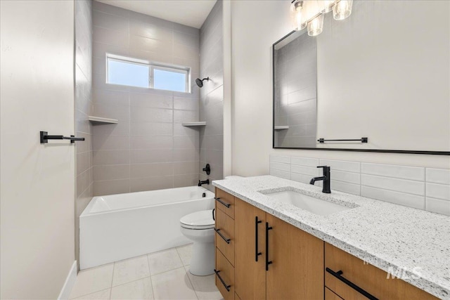 full bathroom with toilet, vanity, tile patterned flooring, backsplash, and tiled shower / bath