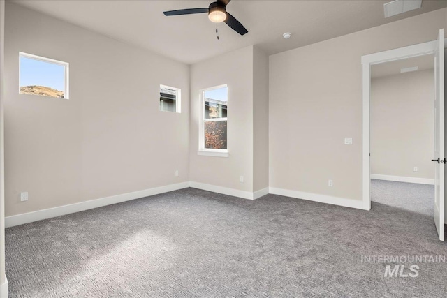 carpeted spare room with ceiling fan