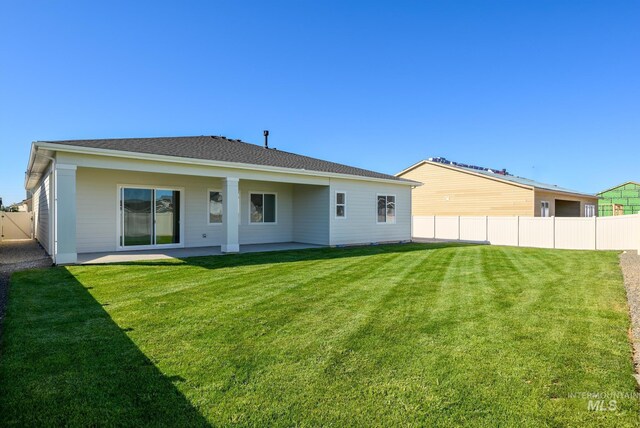 ranch-style home featuring a garage and a front lawn