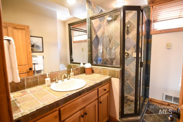 full bath featuring visible vents, a stall shower, and vanity