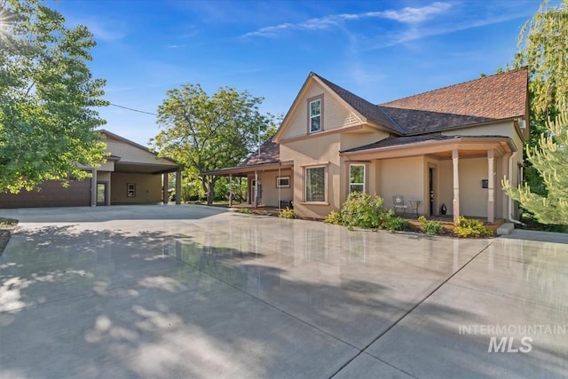 316 Maple Ave, Emmett, ID 83617 - view of front of house featuring stucco siding, driveway, and covered porch