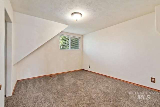 316 Maple Ave, Emmett, ID 83617 - additional living space with carpet flooring, baseboards, a textured ceiling, and lofted ceiling