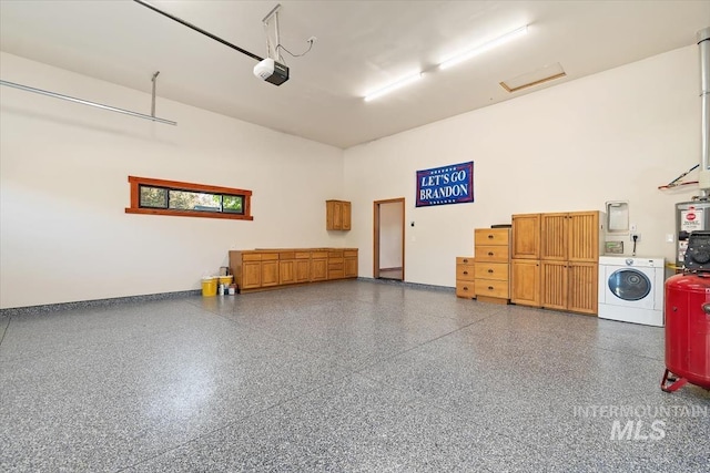 316 Maple Ave, Emmett, ID 83617 - garage featuring washing machine and dryer, a garage door opener, and baseboards
