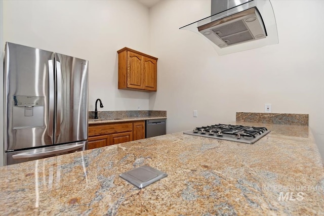 316 Maple Ave, Emmett, ID 83617 - kitchen featuring appliances with stainless steel finishes, range hood, a sink, brown cabinetry, and light stone counters