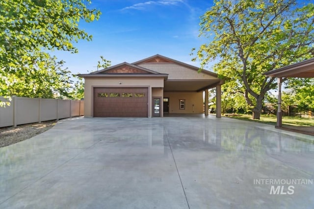 316 Maple Ave, Emmett, ID 83617 - view of front of house with driveway, a garage, a carport, and stucco siding