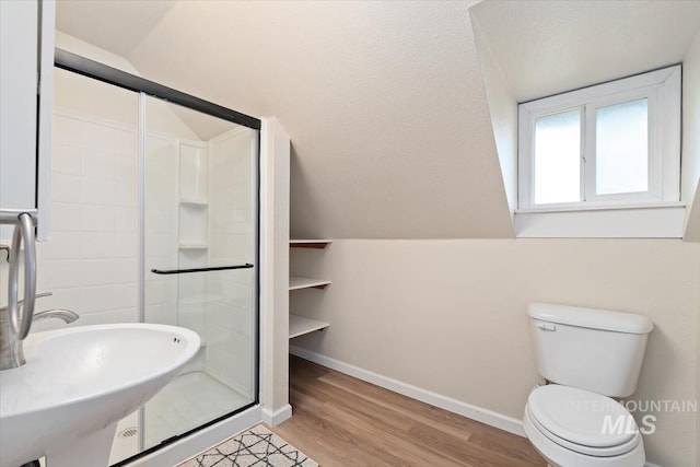 316 Maple Ave, Emmett, ID 83617 - bathroom featuring wood finished floors, a stall shower, baseboards, toilet, and a sink