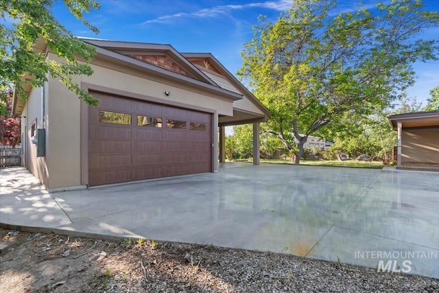 316 Maple Ave, Emmett, ID 83617 - view of side of home with stucco siding, driveway, and an attached garage