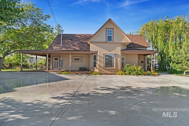 316 Maple Ave, Emmett, ID 83617 - view of front of property featuring stucco siding, a carport, driveway, and covered porch