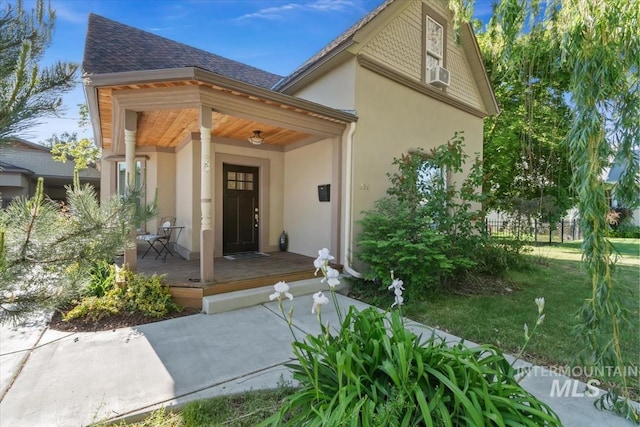 316 Maple Ave, Emmett, ID 83617 - view of exterior entry featuring stucco siding, covered porch, and roof with shingles