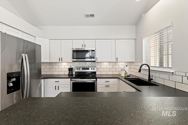 kitchen with a sink, visible vents, tasteful backsplash, and appliances with stainless steel finishes