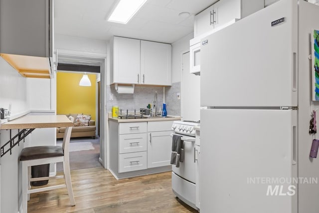 2517/2519 N 21st, Boise, ID 83702 - kitchen featuring white cabinets, light wood-type flooring, and white appliances