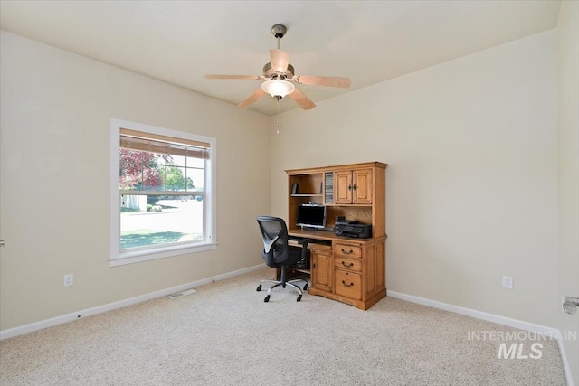 office area featuring light carpet and ceiling fan