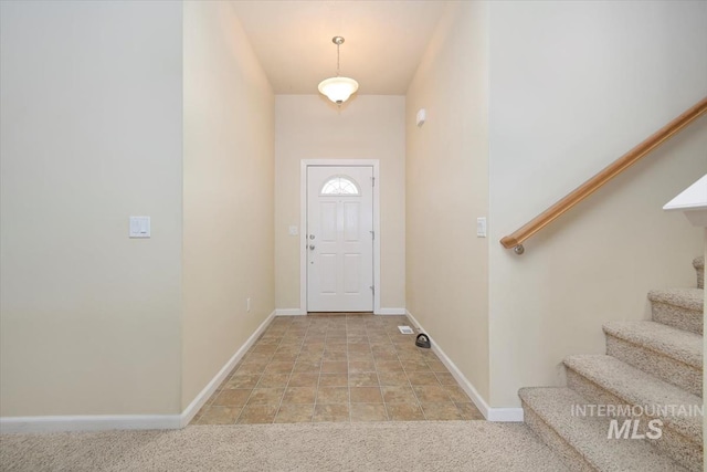 foyer entrance with light colored carpet