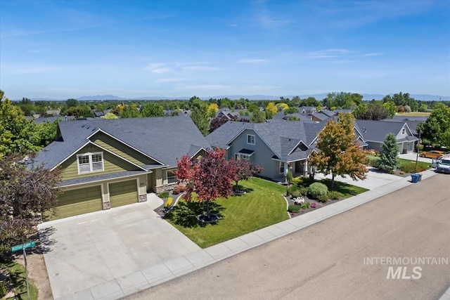 view of front of property featuring a front lawn and a garage