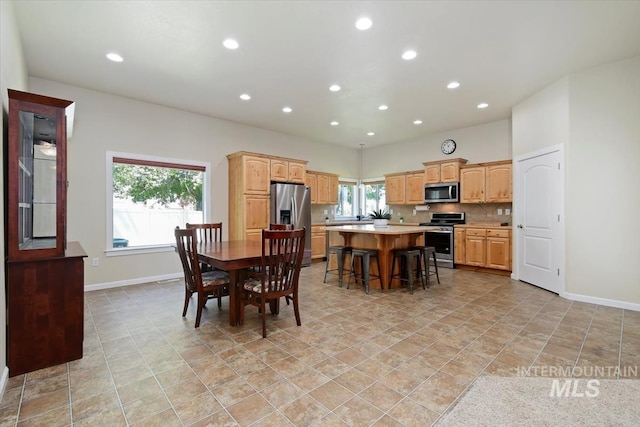 tiled dining room featuring a healthy amount of sunlight