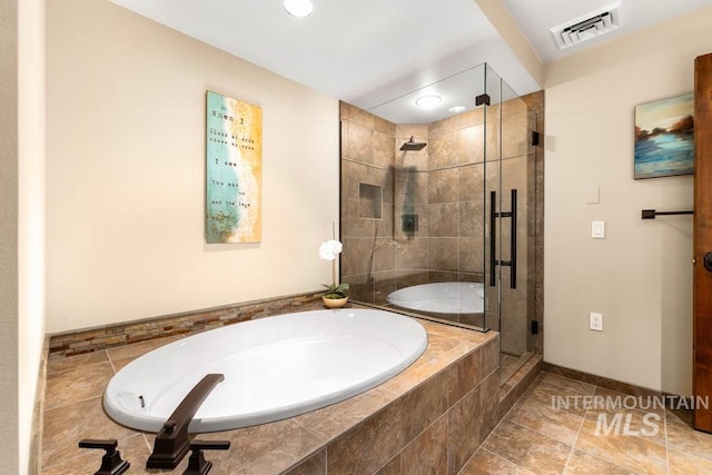bathroom featuring a garden tub, a stall shower, baseboards, and recessed lighting