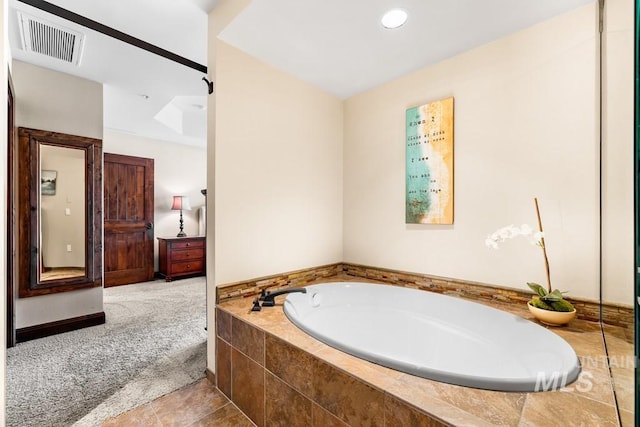 bathroom featuring a bath and recessed lighting