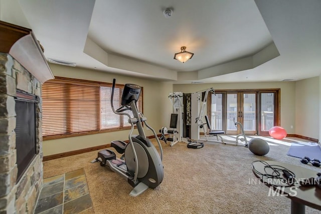 exercise area with carpet flooring, baseboards, and french doors