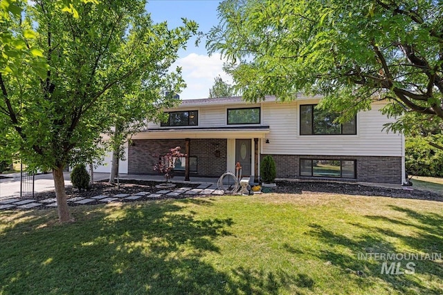 view of front of house with a front lawn and a patio