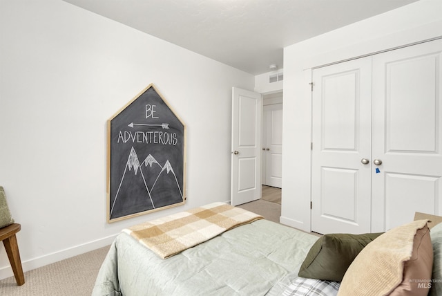 bedroom featuring a closet and light colored carpet