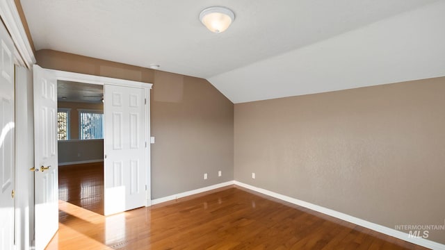 bonus room featuring vaulted ceiling, wood finished floors, and baseboards