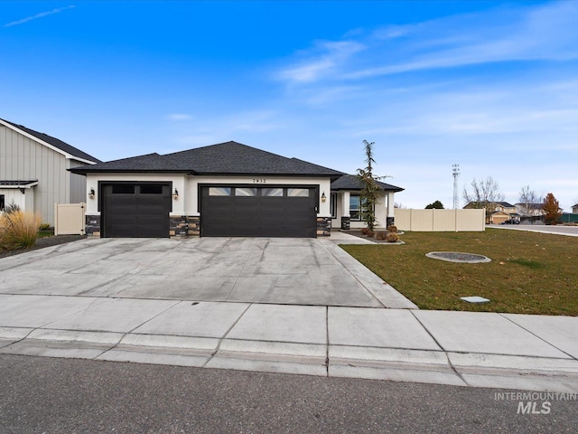 view of front of property with a garage and a front lawn