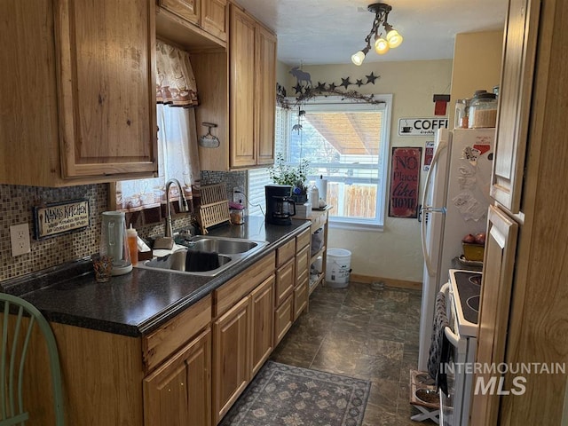 kitchen with baseboards, dark countertops, backsplash, a sink, and white range with electric cooktop