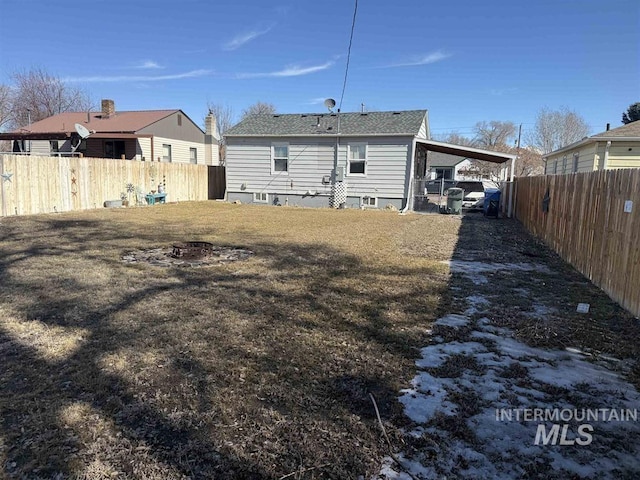 back of house with a carport and fence private yard