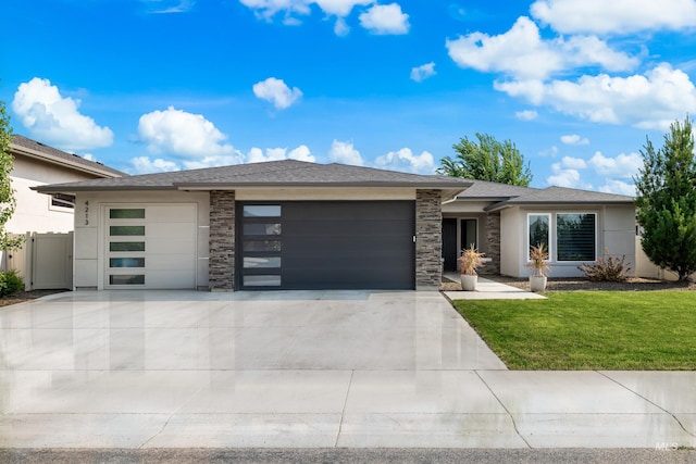 4213 E Divide Pass St, Meridian, ID 83642 - prairie-style home featuring an attached garage, driveway, a front lawn, and stone siding