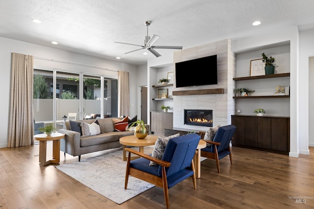 4213 E Divide Pass St, Meridian, ID 83642 - living area featuring a textured ceiling, ceiling fan, wood finished floors, a tile fireplace, and recessed lighting