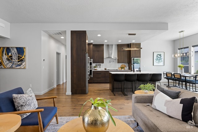 4213 E Divide Pass St, Meridian, ID 83642 - living area featuring wood finished floors, a chandelier, and recessed lighting