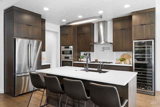 4213 E Divide Pass St, Meridian, ID 83642 - kitchen with wine cooler, appliances with stainless steel finishes, modern cabinets, wall chimney exhaust hood, and light countertops