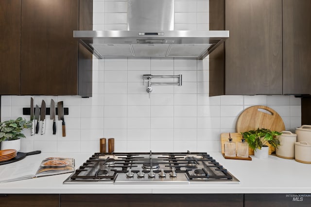 4213 E Divide Pass St, Meridian, ID 83642 - kitchen with wall chimney range hood, dark brown cabinetry, and decorative backsplash