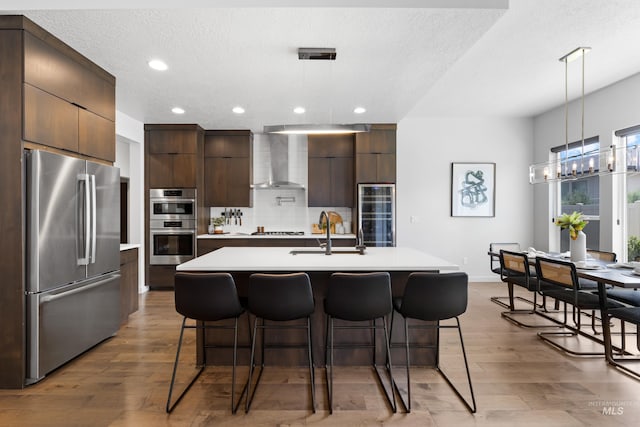4213 E Divide Pass St, Meridian, ID 83642 - kitchen with stainless steel appliances, modern cabinets, wall chimney exhaust hood, wine cooler, and recessed lighting