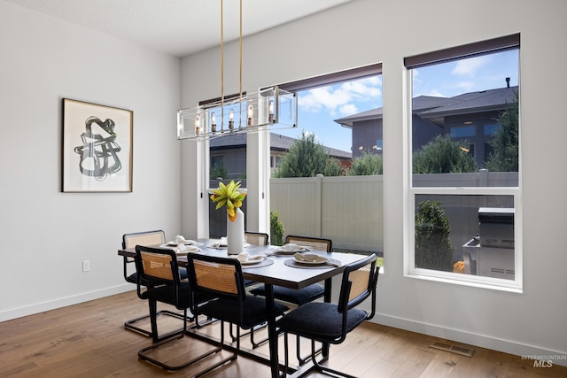 4213 E Divide Pass St, Meridian, ID 83642 - dining space featuring a chandelier and hardwood / wood-style flooring