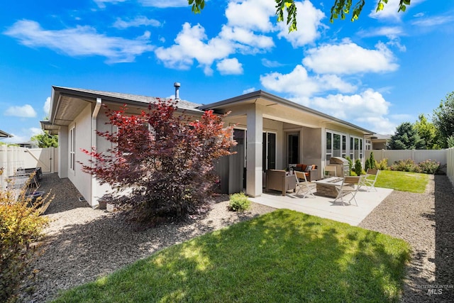4213 E Divide Pass St, Meridian, ID 83642 - rear view of property featuring stucco siding, a patio area, a fenced backyard, and an outdoor living space