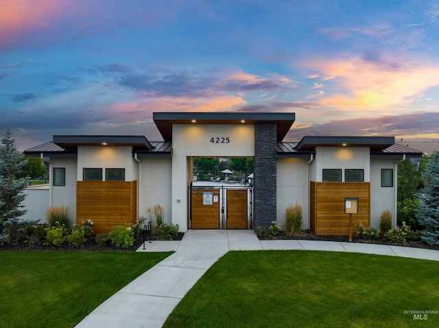 4213 E Divide Pass St, Meridian, ID 83642 - contemporary house with a standing seam roof, stucco siding, a front lawn, and a metal roof
