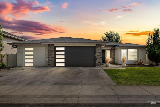 4213 E Divide Pass St, Meridian, ID 83642 - prairie-style home with an attached garage, driveway, a yard, and stone siding