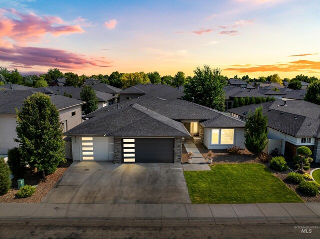 4213 E Divide Pass St, Meridian, ID 83642 - view of front of house featuring an attached garage, concrete driveway, a shingled roof, and a residential view
