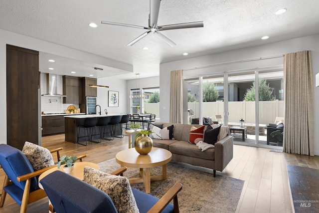 4213 E Divide Pass St, Meridian, ID 83642 - living room with light wood-type flooring, a textured ceiling, ceiling fan, and recessed lighting