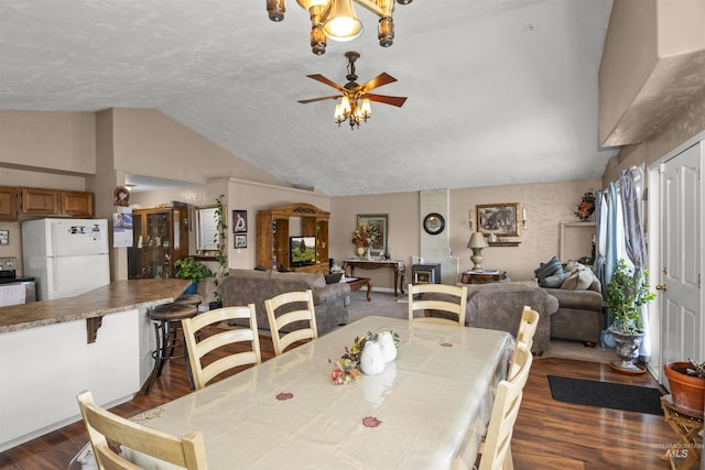 642 Oak St, Twin Falls, ID 83301 - dining space with lofted ceiling, dark wood-style flooring, ceiling fan, and a chandelier