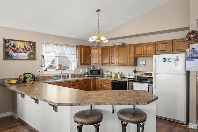 642 Oak St, Twin Falls, ID 83301 - kitchen featuring appliances with stainless steel finishes, a sink, brown cabinets, vaulted ceiling, and a chandelier