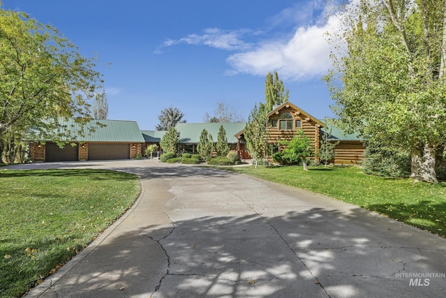 view of front of house featuring a front yard and a garage