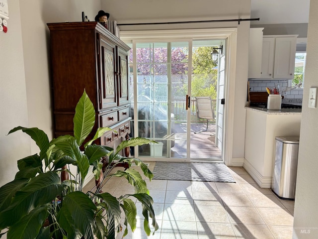 entryway featuring baseboards and light tile patterned floors