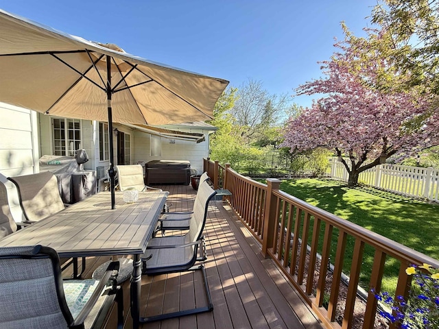 deck with area for grilling, a jacuzzi, a fenced backyard, a yard, and outdoor dining space
