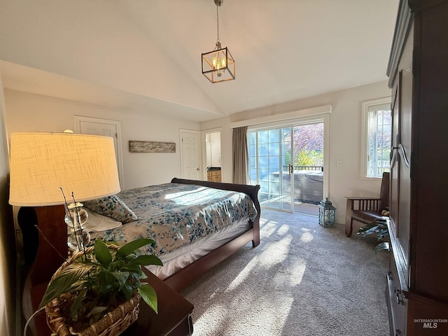 carpeted bedroom featuring high vaulted ceiling, an inviting chandelier, and access to exterior