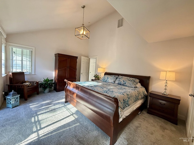 bedroom featuring high vaulted ceiling, carpet flooring, and a chandelier