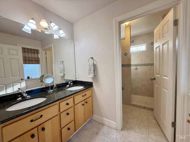 bathroom with a sink, walk in shower, and a wealth of natural light