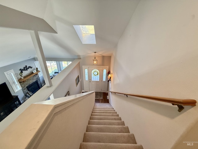 stairs featuring a skylight
