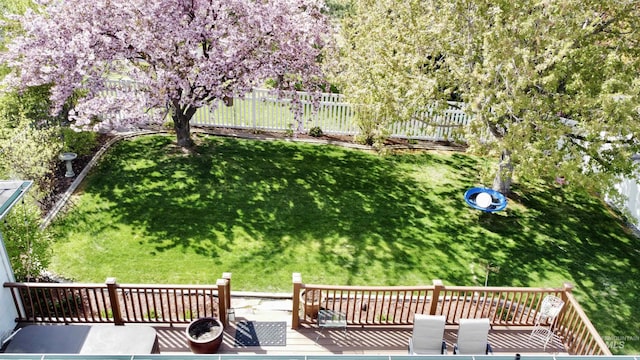 view of yard featuring fence and a wooden deck
